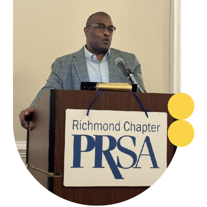 Man speaking at podium for PRSA